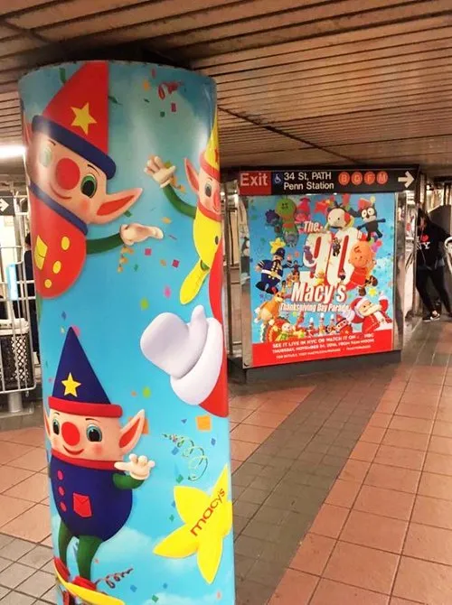 Subway station pillar wrapped in colourful parade balloon artwork