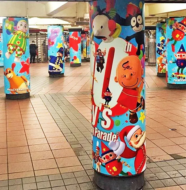 Row of subway station pillars wrapped in Thanksgiving Day Parade characters